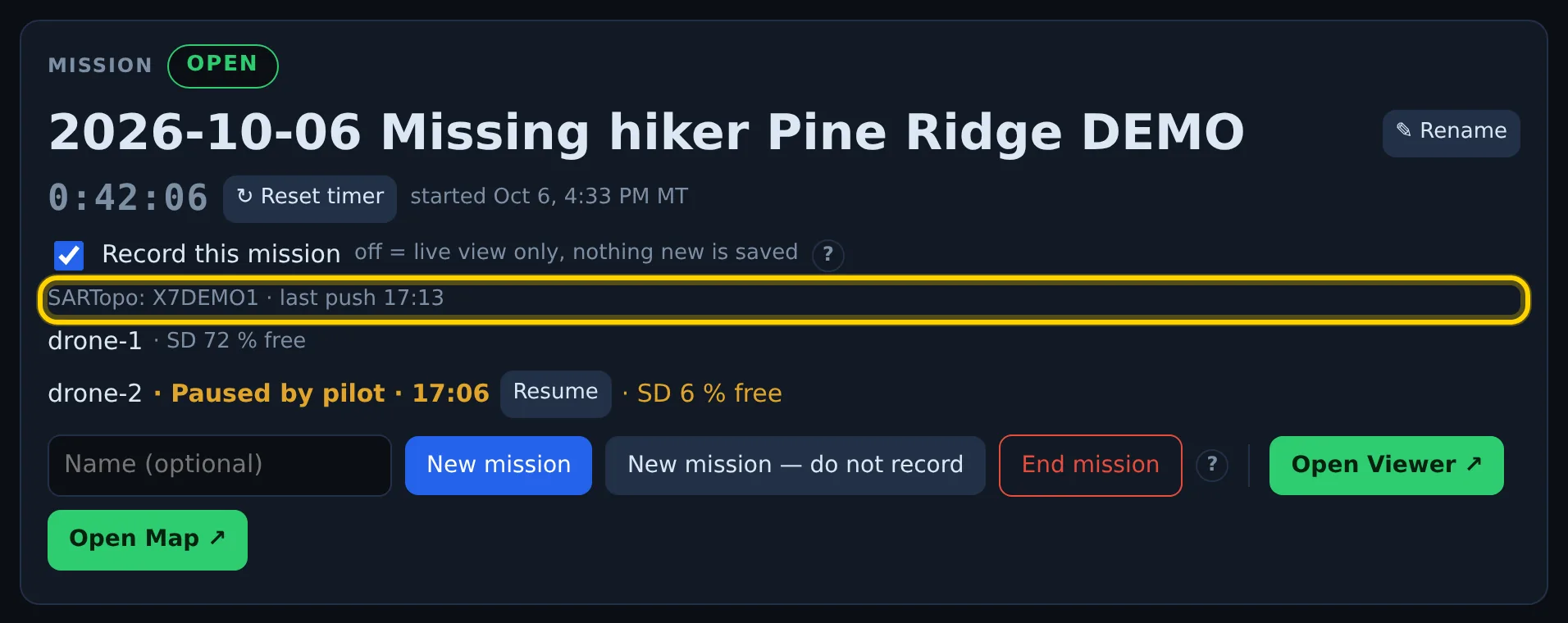 The Mission card: mission name, timer, Record this mission, the line "SARTopo: X7DEMO1 · last push 17:13" outlined, and two drones below it — drone-1 with its SD card space, drone-2 "Paused by pilot" with a Resume button